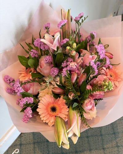 Customer's beautiful Florist Choice Bouquet featuring a vibrant mix of pink, peach, and purple flowers.