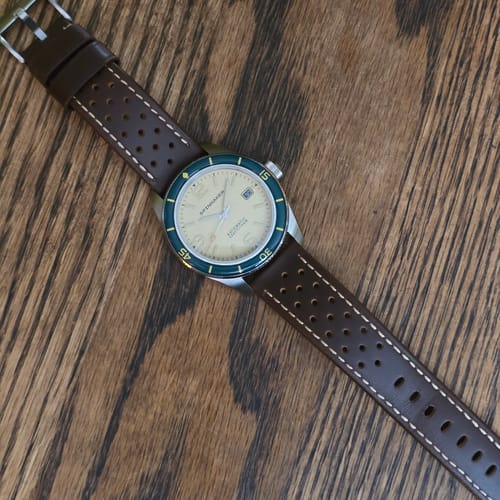 Reviewer's brown perforated Leather Sport Grip strap with tan stitching, attached to a watch with a cream dial and dark bezel.
