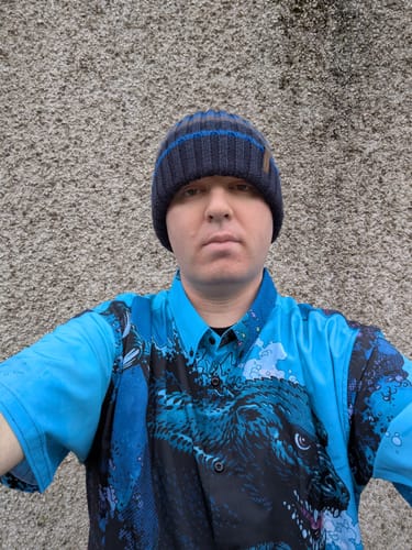 Customer wearing the blue Godzilla 'From the Depths' shirt, showing the large, detailed kaiju graphic.