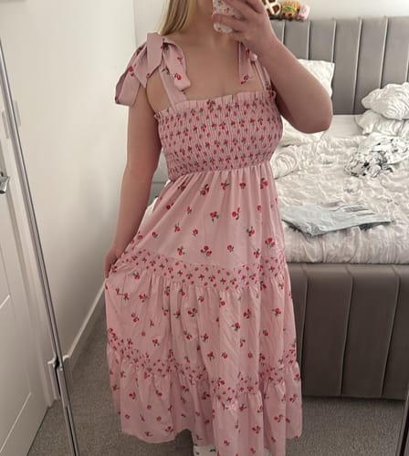 Customer wearing the Faye Soft Rose Maxi Dress, showing its smocked top and rose pattern.