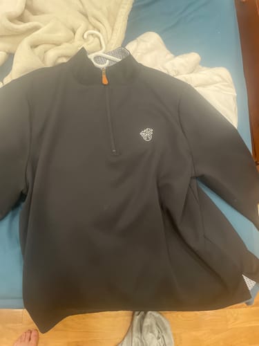 Customer's black Reversible Infinity 1/4 Zip laid out, showing the thick material and patterned inside collar.