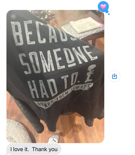 Customer displays a black T.V.P. Elite Membership t-shirt with the text 'BECAUSE SOMEONE HAD TO. HONOR THEM ALWAYS'.