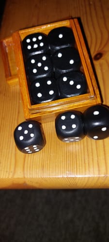 Reviewer's Secret Dice Box, showing the small wooden box with black dice inside and on a wooden table.