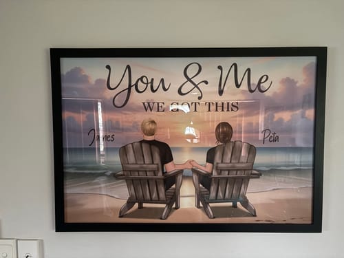 Customer's personalized "Eternal Love" poster, framed and hung on a wall, showing a couple on a beach with the names James and Peta.