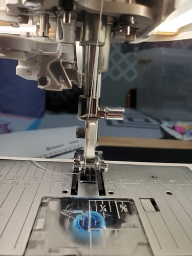 Customer's close-up of the Viking Needle Holder installed on a sewing machine, threaded and ready to use.