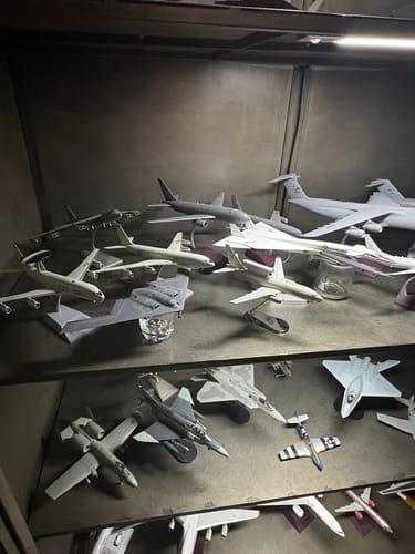 Customer's GEMINI200 USAF C5M model displayed in a lit case with a large collection of other model planes.