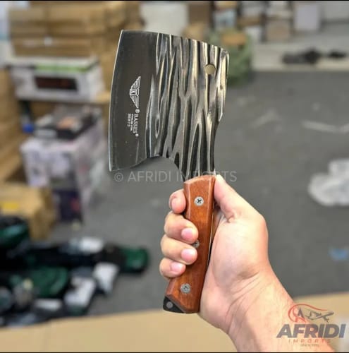 Customer holding the Basses Stainless Steel Cleaver, showing its textured blade and wooden handle.