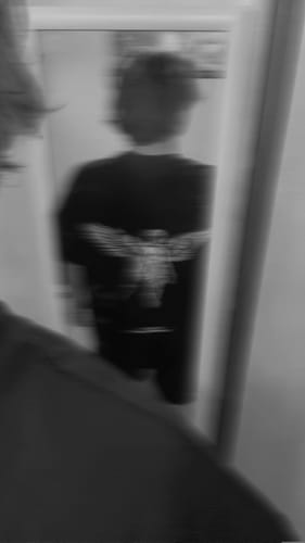 Reviewer's blurry, black and white photo showing the back graphic of the Victory T-shirt.