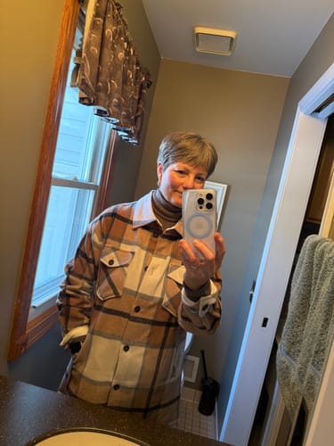 Reviewer taking a mirror selfie wearing the Sutton Shacket in Camel Plaid layered over a turtleneck.