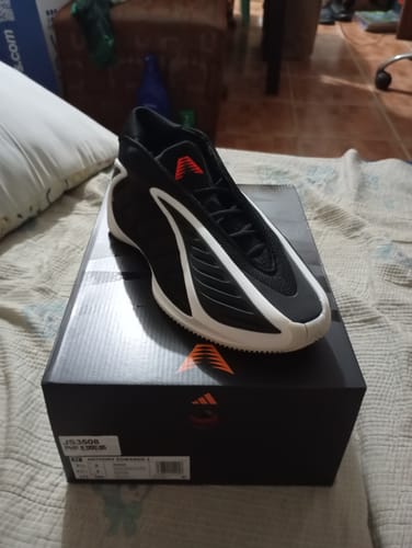 Reviewer's black and white adidas Anthony Edwards 2 basketball shoe resting on top of its original shoebox.