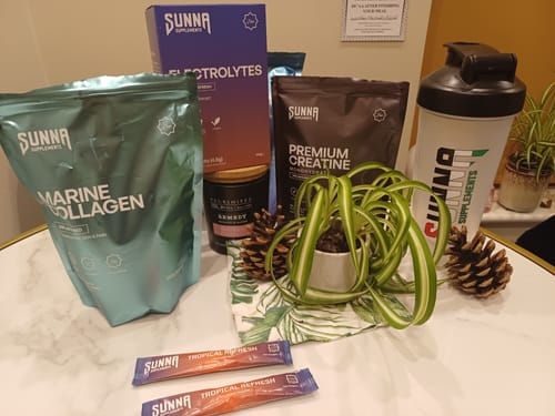 Customer's teal pouch of Sunna Marine Collagen displayed on a table with other supplements from the brand.