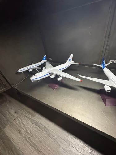 Customer's AN124 model airplane displayed in a dark cabinet with other model planes.