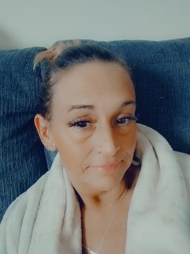 Reviewer wearing the long, fluttery Flutter lashes while relaxing indoors.