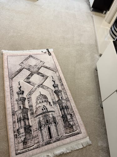 Customer's Zamrad Padded Prayer Mat with a beautiful mosque design laid out on a carpeted floor.