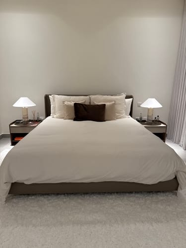 Reviewer's King Size Bed B032 neatly made with white bedding and pillows in a modern, luxurious bedroom.