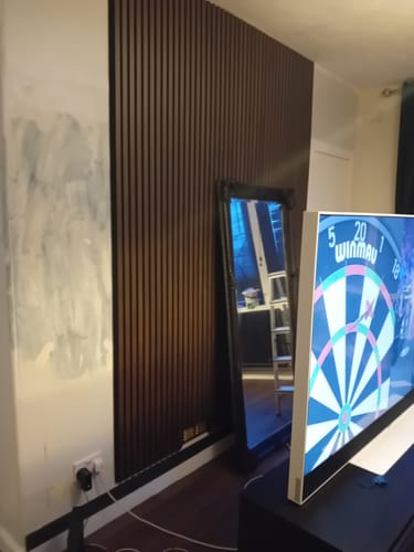 Customer's review showing the Walnut Acoustic Wall Panels installed as a feature wall in a room.