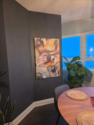 Customer's 'Gratitude' Framed Canvas hanging in the corner of a room with dark gray walls.