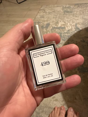Customer holding a clear 30ml bottle of No. 499 perfume in their hand.
