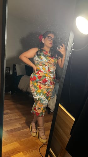 Reviewer posing in a mirror wearing the colorful 1960s Retro Crop Top & Pencil Skirt set.