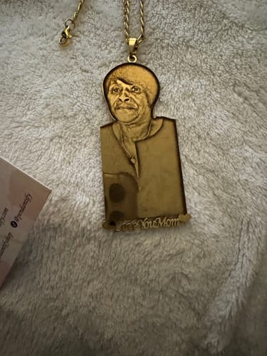 Customer's gold photo engraved pendant necklace showing a portrait of a woman and the text 'Love You Mom'.