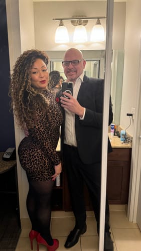 Reviewer in a bodycon Burnout Print Mini Dress and pantyhose, posing for a mirror selfie.