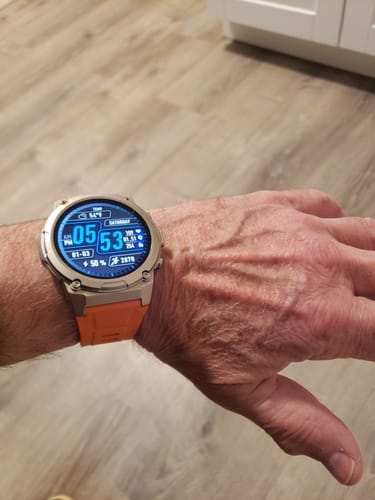Customer's Gard Pro Ultra 3 watch with an orange band, showing the large, data-rich digital face on their wrist.