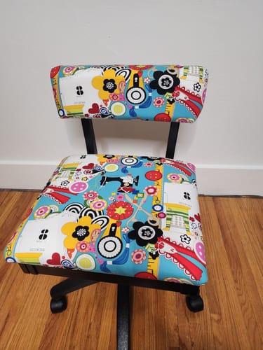 Customer's Arrow Hydraulic Sewing Chair with colorful, sewing-themed upholstery shown fully assembled.