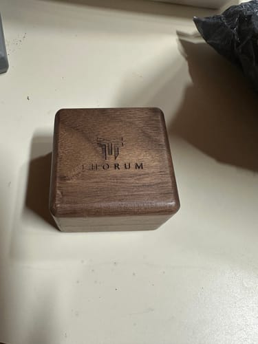 Customer's wooden Thorun brand box for the WW2 Ring, shown closed on a surface.