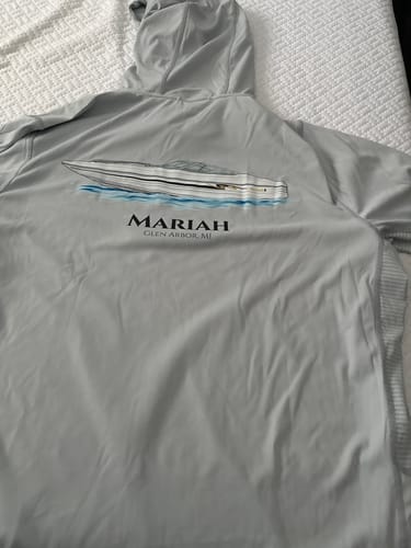 Customer's gray hooded shirt with their custom boat artwork, the 'Mariah', printed on the back.