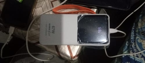 Customer's white 67W powerbank on a surface, with the digital display showing 68% battery remaining.
