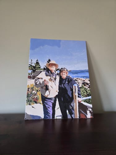Customer's finished painting from the Custom Paint by Numbers Kit, showing a portrait of two people on a canvas board.