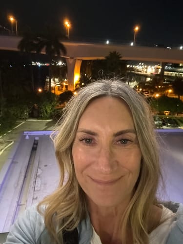 A smiling reviewer takes a selfie at night, showing her Lashify lashes.