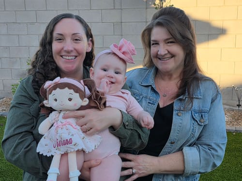 Customer's family photo with a baby holding a personalized Leyadoll soft doll.