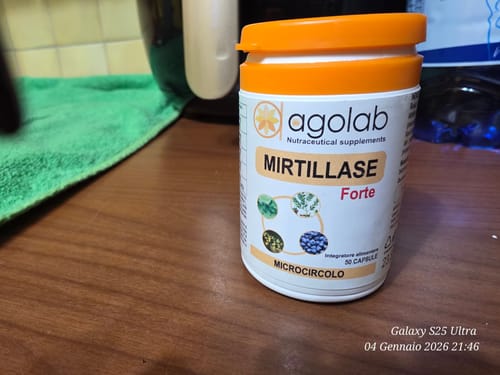 Il recensore mostra il flacone di Mirtillase Forte su un tavolo di legno.
