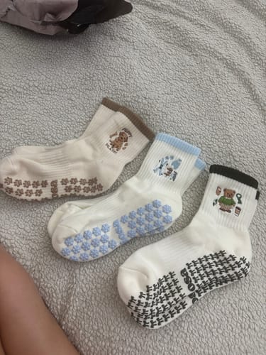 Customer's three pairs of Merry Beary socks laid out, showing the various cute designs and grippy soles.