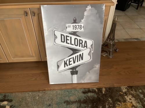 Customer's personalized black and white canvas with street signs showing the names 'DELORA' and 'KEVIN' and 'EST. 1978'.