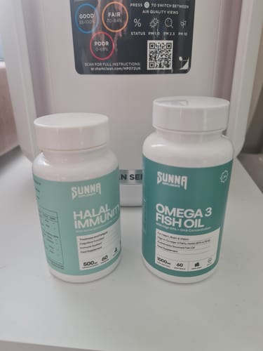 Customer's bottle of Halal Immunity supplements sitting on a white counter next to another supplement.
