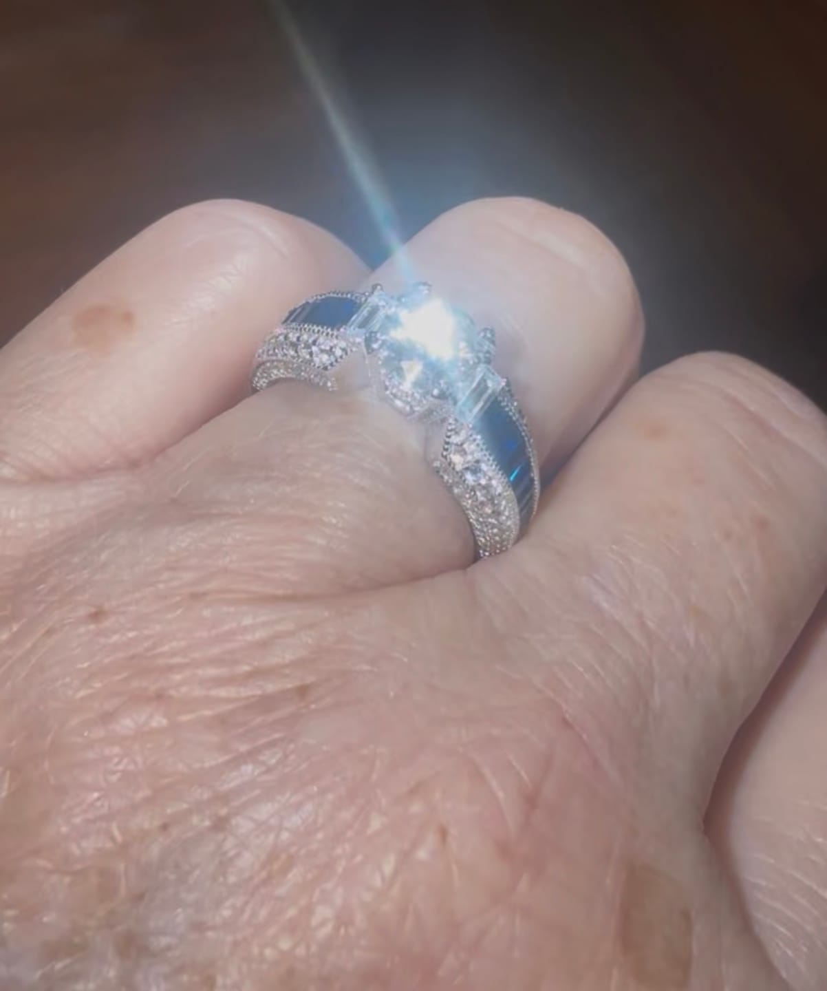 Customer photo review of Round Moissanite And Emerald-Cut Sapphire Channel Set Milgrain Engagement Ring