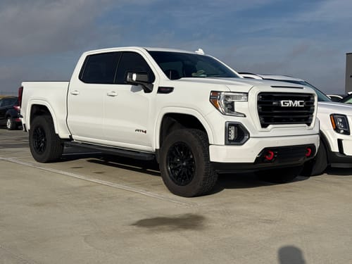 Customer's white GMC AT4 truck with a 2-inch lift after installing the Upper Control Arms.