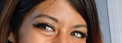 Close-up of a reviewer's eyes wearing the Vela Dark Brown contact lenses, which appear light brown.