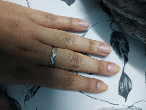 Customer's hand wearing the Silver Zircon Vine Shine Ring, showing its delicate zircon-studded vine design.