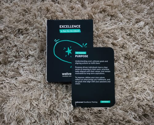 Reviewer's Wellversed Learning Cards box with the 'Purpose' card displayed on a shaggy carpet.