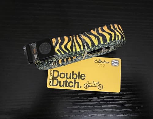 Customer's flashy Double Dutch String with a detailed tiger-stripe pattern, shown coiled with its card.