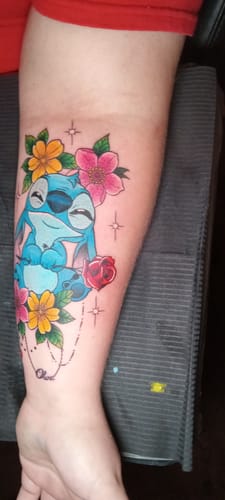Customer's colorful character tattoo on their forearm, completed after using Painless Tattoo Numbing Cream.
