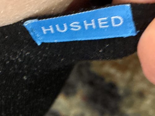 Close-up of the brand tag on a customer's black Performance Eucalyptus Compression Socks.