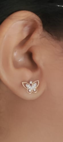 Customer wearing the Gold Butterfly Lab Grown Diamond Stud earring in a close-up photo.