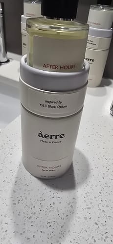 Customer's After Hours perfume bottle displayed inside its white branded case on a countertop.