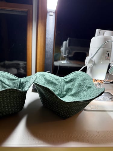 Customer's two green patterned bowl cozies made using the Creative Grids Bowl Cozy Template Set.
