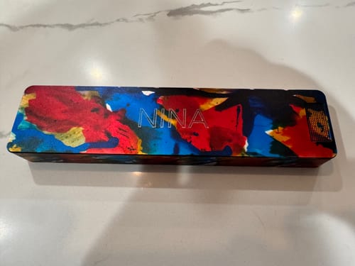 Reviewer's custom Weekly Case with a colorful abstract design and the name 'Nina' on the lid.