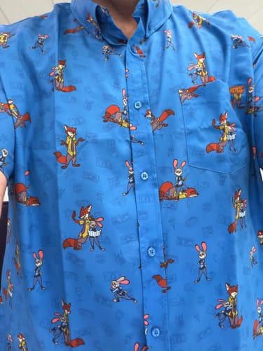 Customer's close-up of the blue Disney's Zootopia "Paw & Order" shirt, showing the detailed character pattern.